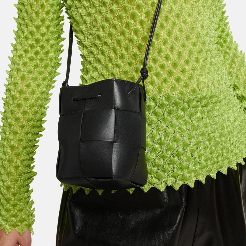 Lightweight leather woven mini bucket handbag in white with crossbody strap, black