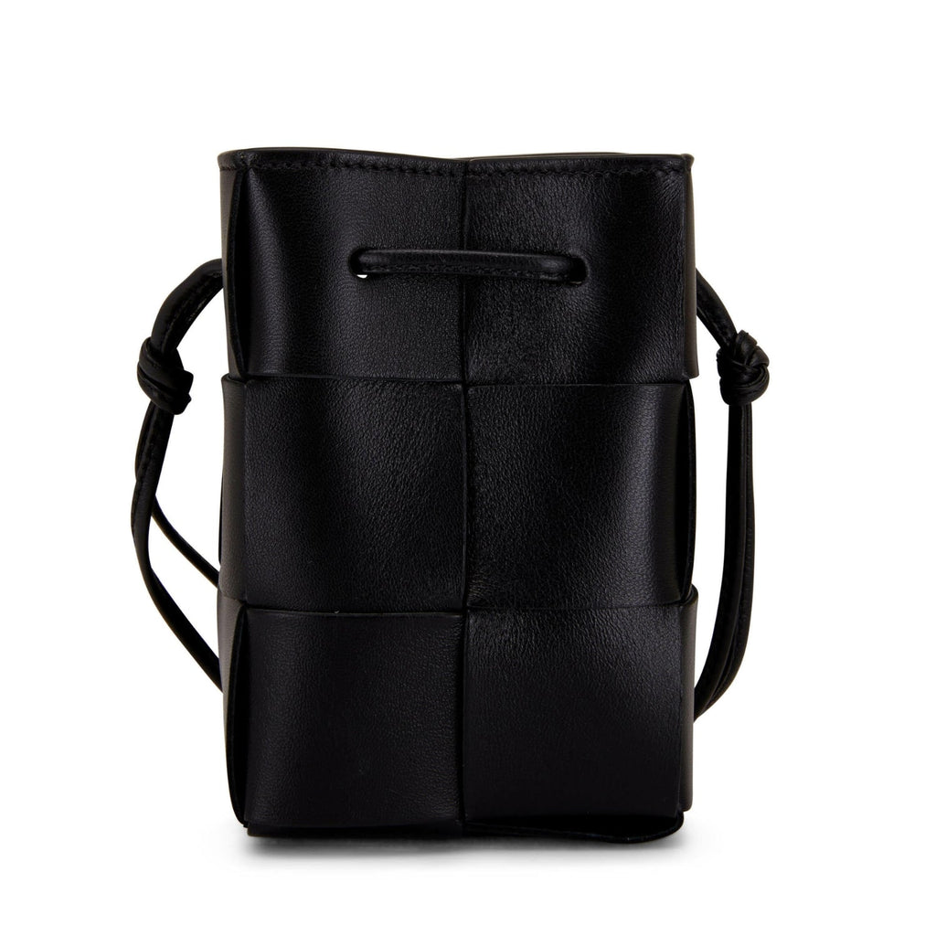 Lightweight leather woven mini bucket handbag in white with crossbody strap, black