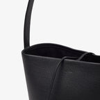 Vertical soft leather tote in black — leather grain detail