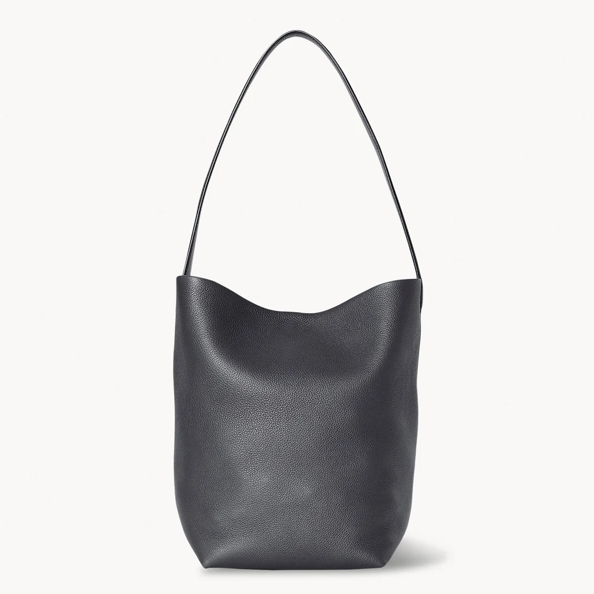 Front view of the natural grain and soft drape on a Park Tote inspired medium leather bag in black