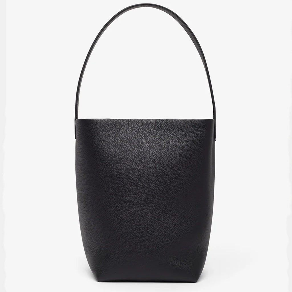 Front view of the natural grain and soft drape on a Park Tote inspired medium leather bag in black