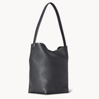 Vertical soft leather tote in black — side view