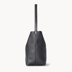 Vertical soft leather tote in black — side detail