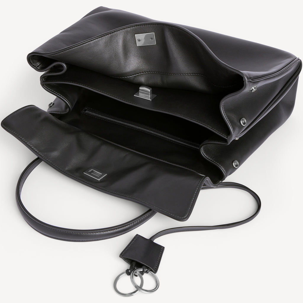 inside of chic black slouchy medium tote bag with polished silver hardware and a relaxed rectangular shape.