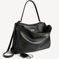 chic black slouchy medium tote bag with polished silver hardware and a relaxed rectangular shape.
