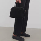 Belted 10 suede leather tote in black — carried by model
