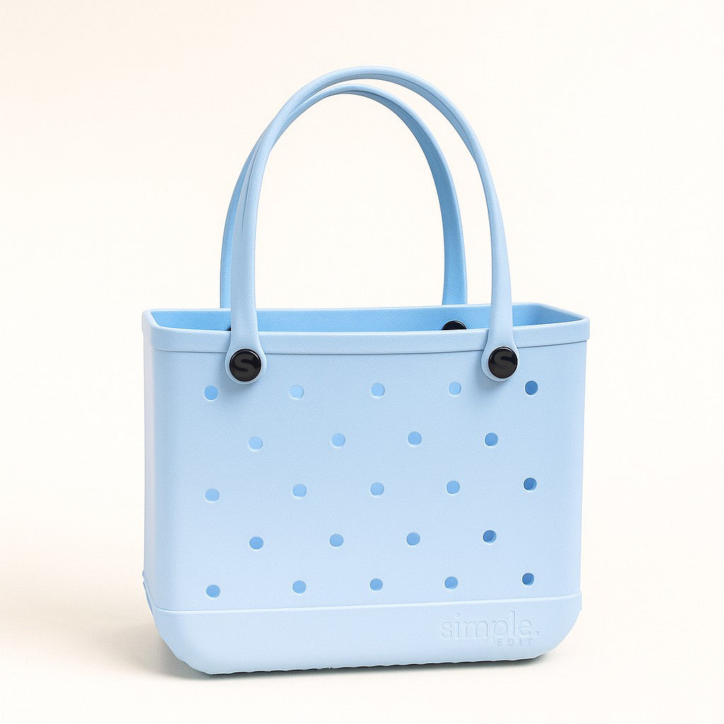 Medium EVA Tote in Blue Skies. Lightweight, waterproof rubber-like EVA bag in sky blue. Ideal for everyday errands, gym, and casual outings.