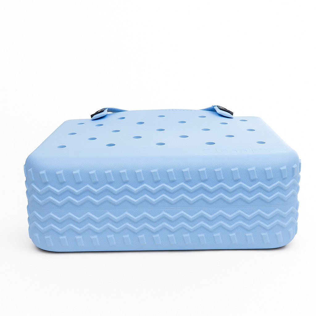 Medium EVA Tote in Blue Skies. Lightweight, waterproof rubber-like EVA bag in sky blue. Ideal for everyday errands, gym, and casual outings.