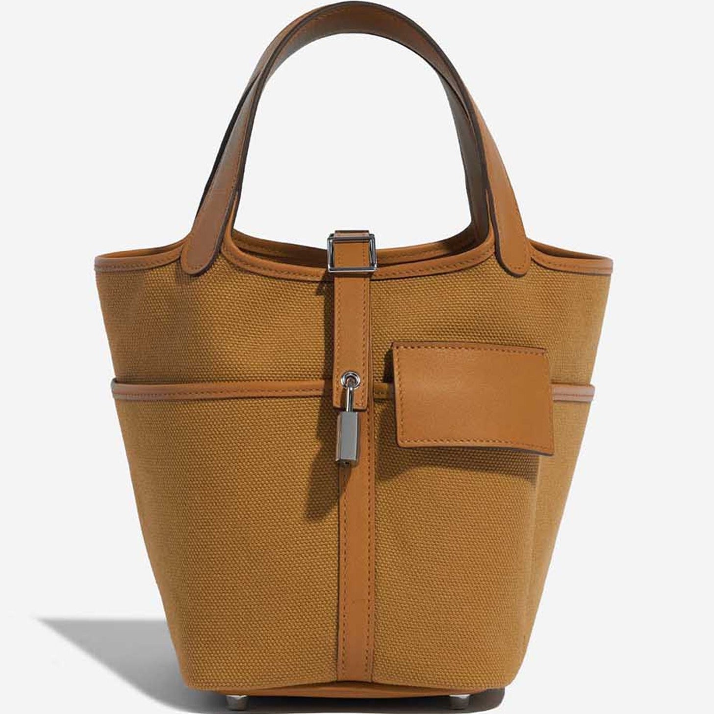 Sesame Beige bucket bag with canvas-style body, vegan leather trim, top-handle, lock strap, and utility side pockets