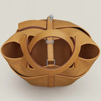 Sesame Beige bucket bag with canvas-style body, vegan leather trim, top-handle, lock strap, and utility side pockets