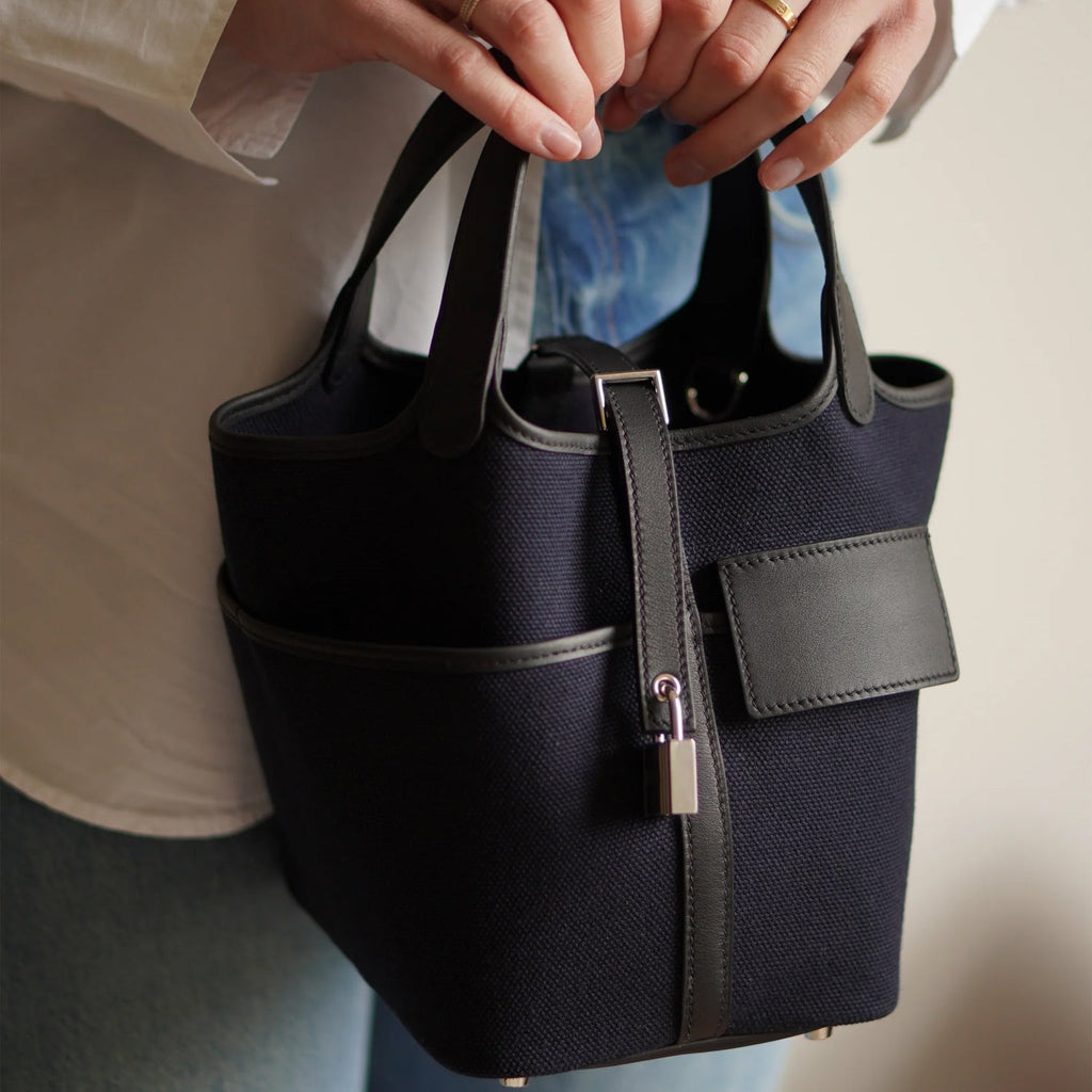 Black canvas tote with silver hardware and side pockets
