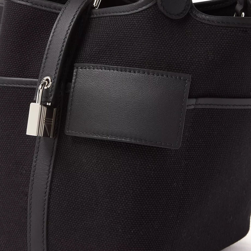 Black canvas tote with silver hardware and side pockets