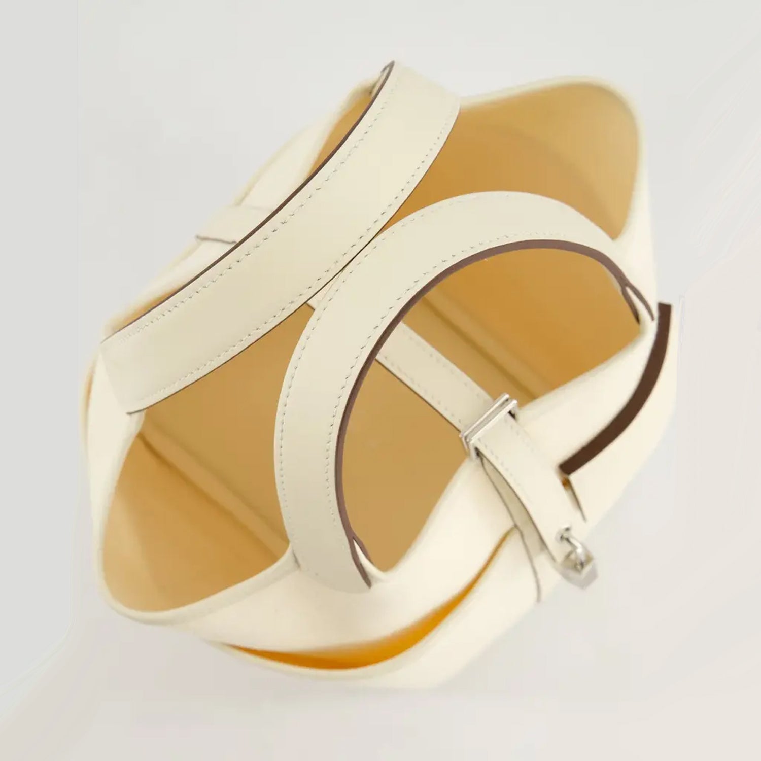 White canvas bucket bag with top handle and structured shape