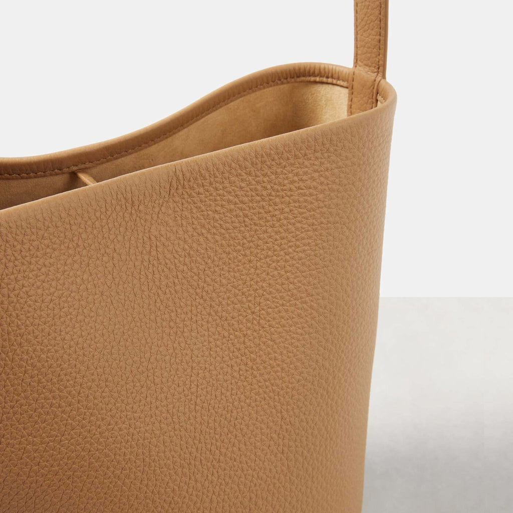 closed up brown camel the N/S Park style medium vertical tote in genuine leather, showcasing its clean rectangular silhouette.