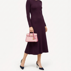 Classic Mini 20 togo leather tote in contrast pink carried by hand, model shot