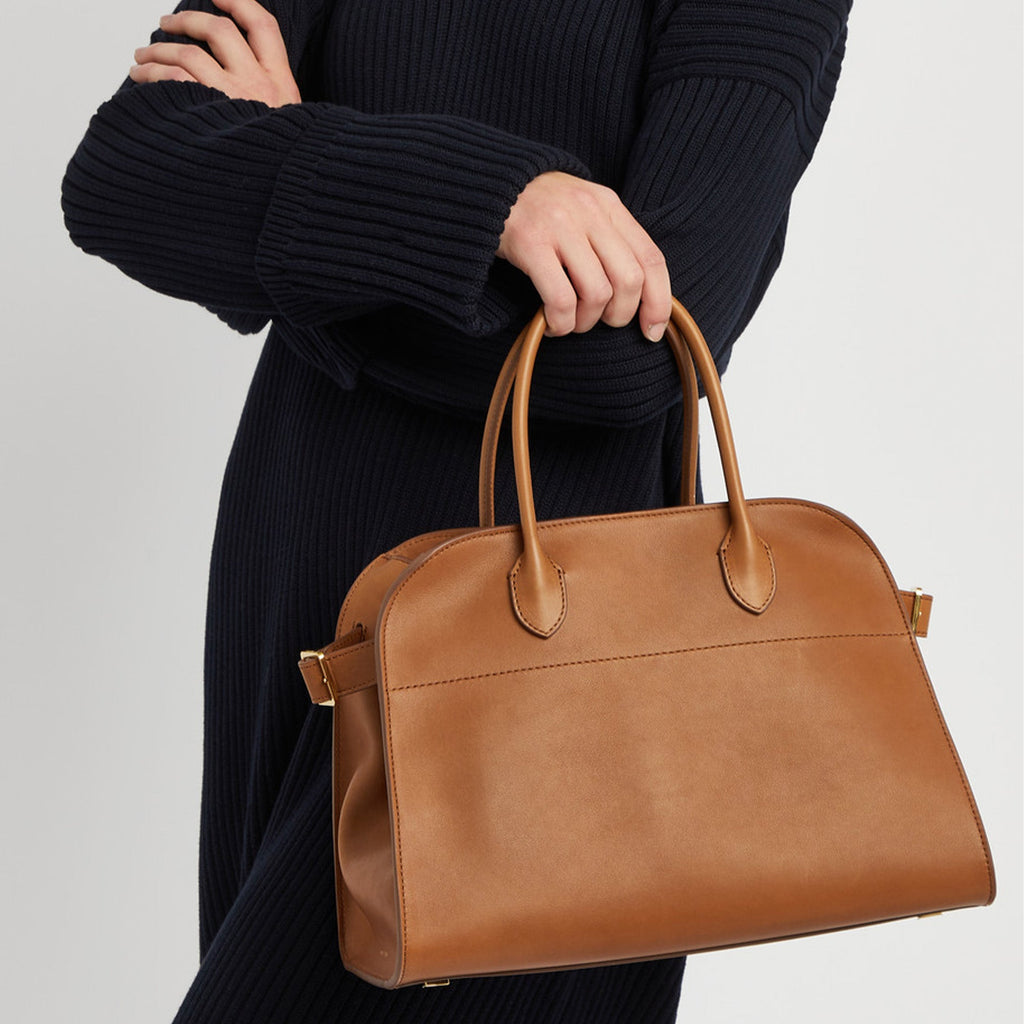 Compact brown tote bag with strap made from vegan PU leather, featuring a structured silhouette, top handles, and a modern minimal design.