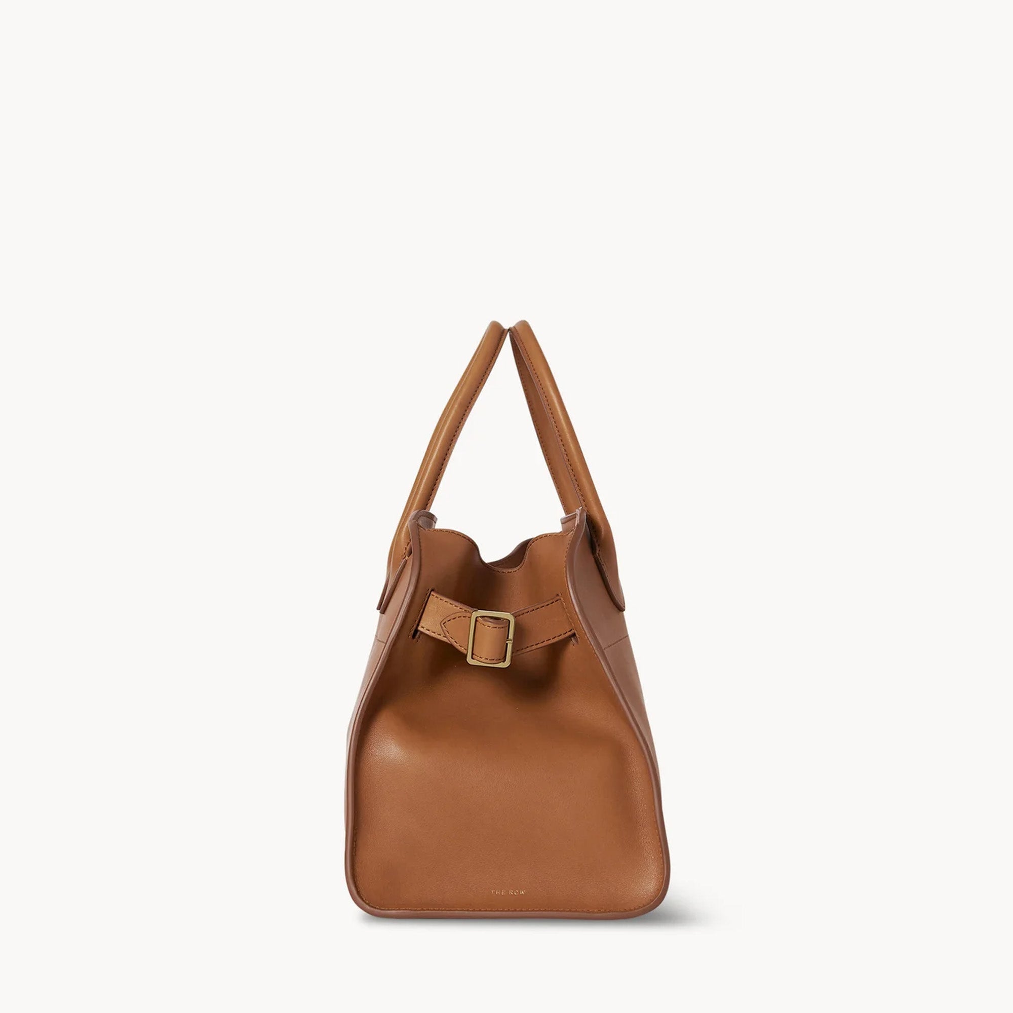 Compact brown tote bag with strap made from vegan PU leather, featuring a structured silhouette, top handles, and a modern minimal design.