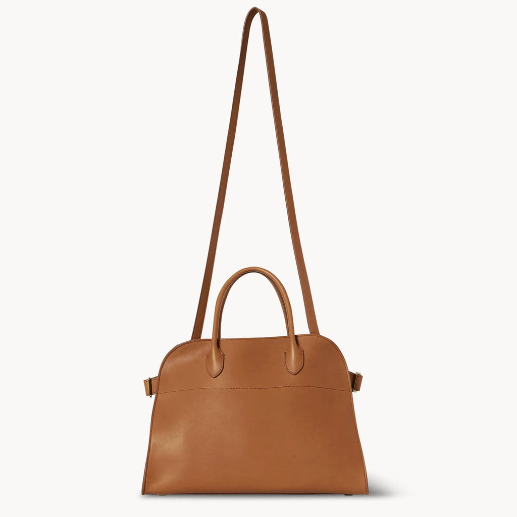 Compact brown tote bag with strap made from vegan PU leather, featuring a structured silhouette, top handles, and a modern minimal design.
