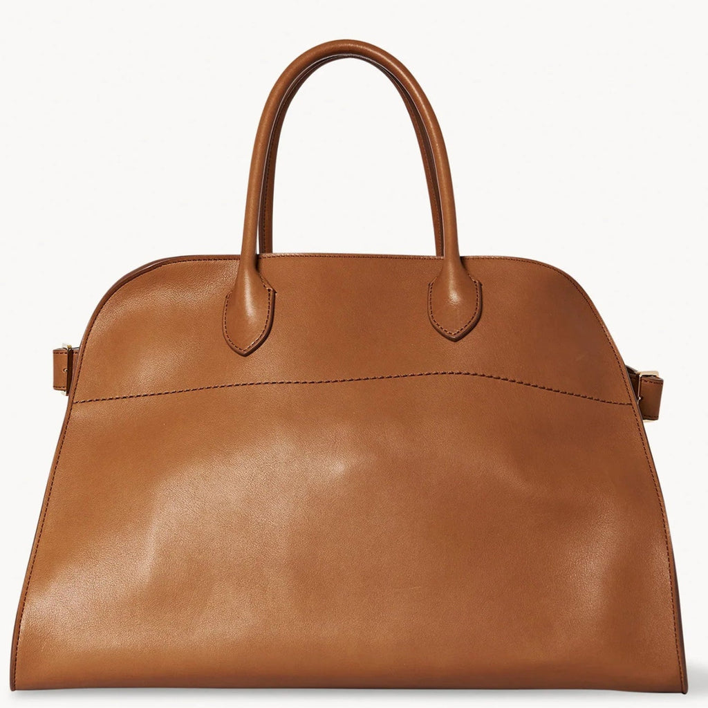 Brown structured tote bag made from premium PU, featuring a soft leather-like texture, minimal silhouette, and top handles – designed for modern, cruelty-free elegance.