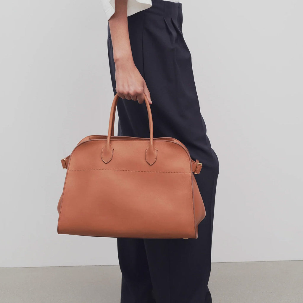 Brown structured tote bag made from premium PU, featuring a soft leather-like texture, minimal silhouette, and top handles – designed for modern, cruelty-free elegance.