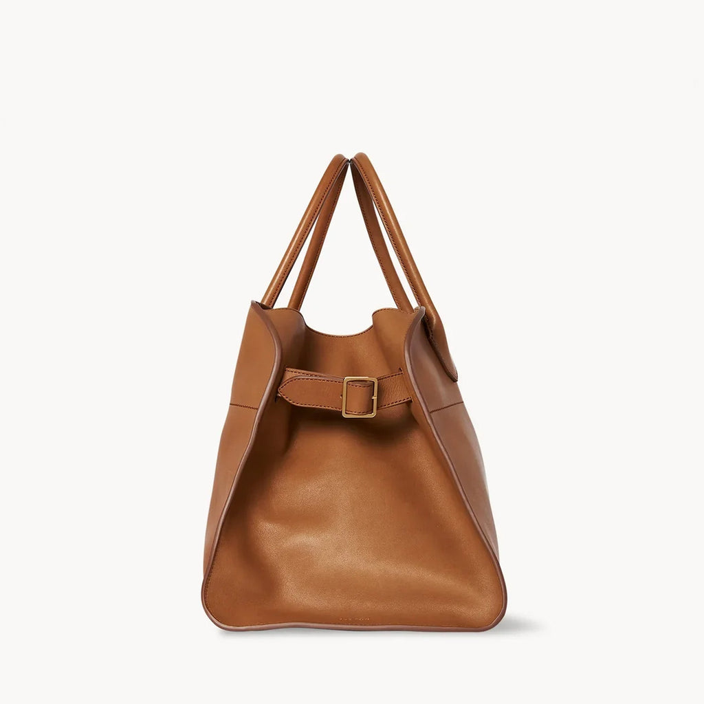 Brown structured tote bag made from premium PU, featuring a soft leather-like texture, minimal silhouette, and top handles – designed for modern, cruelty-free elegance.