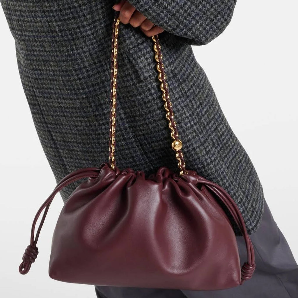 Adjustable Leather Strap and Sculptural Knot Detail – Handheld Clutch Style