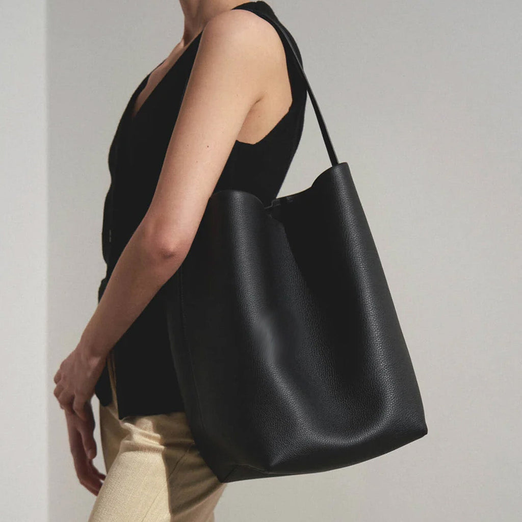 Black slouchy leather tote bag with minimalist silhouette