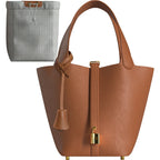 Luxury gold leather bucket bag in premium vegan leather with mini lock design and gold-tone hardware, elegant everyday handbag.