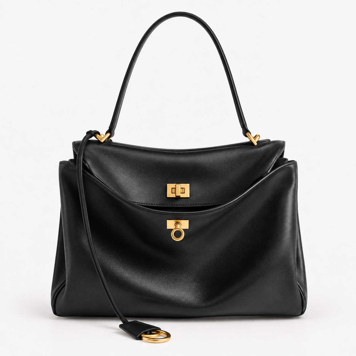 The Slouchy medium leather tote in black — close-up of brassy gold hardware