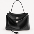 Front view of a black slouchy medium tote bag with polished silver hardware and a relaxed rectangular shape.