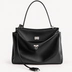 Front view of a black slouchy medium tote bag with polished silver hardware and a relaxed rectangular shape.