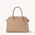 Front view of the Taupe Margaux 10 style compact structured leather tote with belted sides.