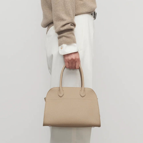 Front view of the Taupe Margaux 10 style compact structured leather tote with belted sides.