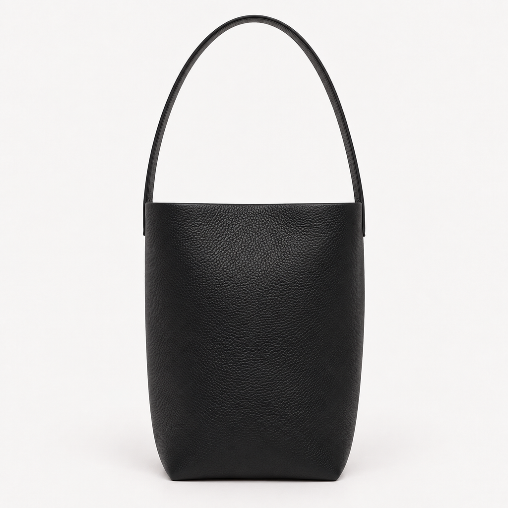 Vertical soft leather tote in black — front view showing natural grain