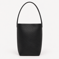 Vertical soft leather tote in black — front view showing natural grain