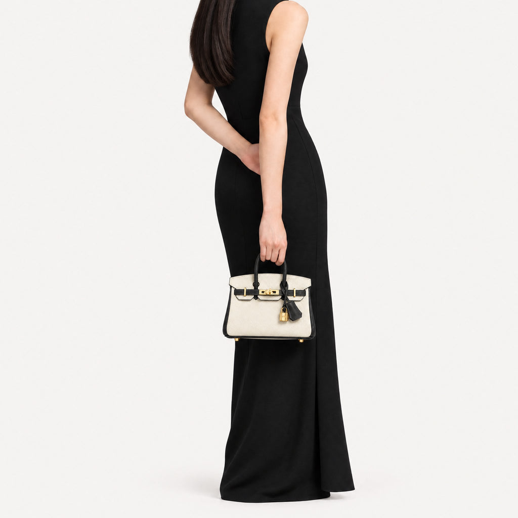 Classic Mini 20 togo leather tote in contrast black and white carried by hand, model shot