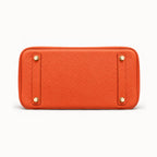 Classic 30 togo leather tote in orange, base view with four protective feet