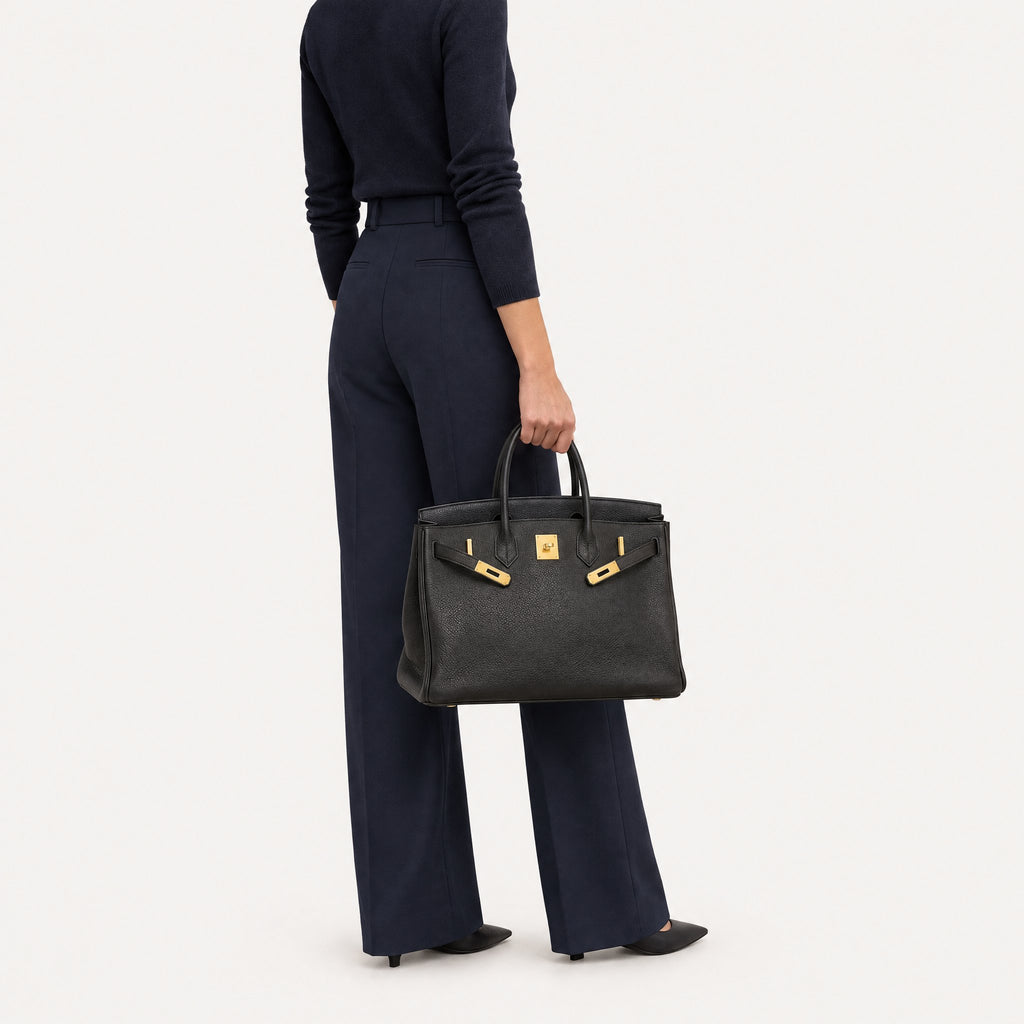 Classic 35 togo leather tote in black carried by hand, model shot