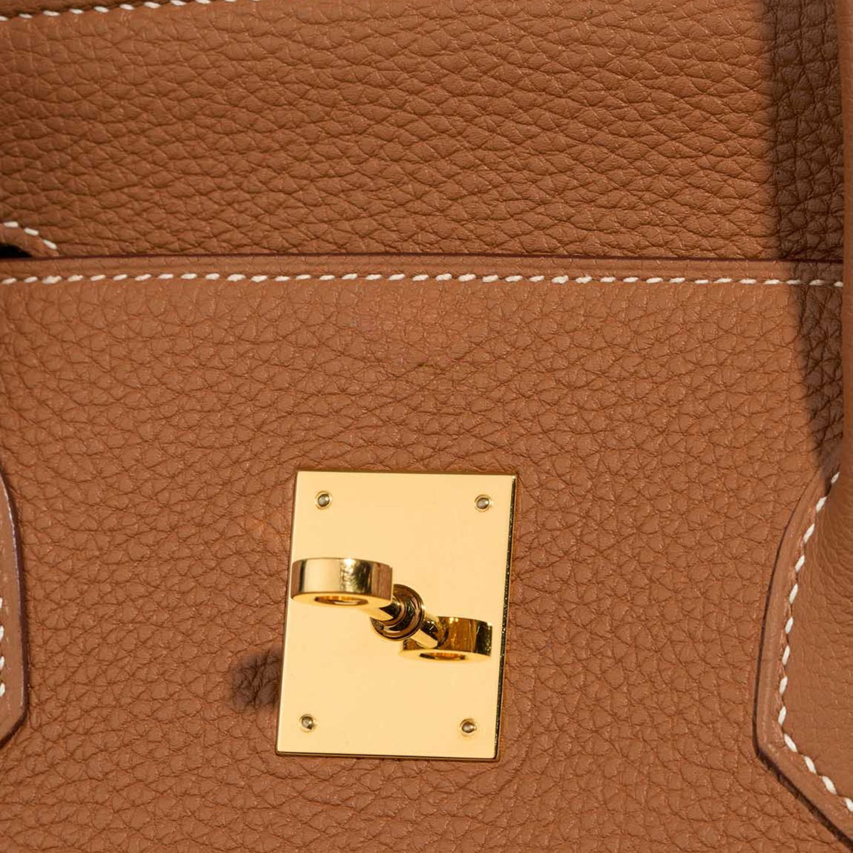 Classic 35 togo leather tote in brown, close-up of pebbled grain and gold-tone lock plate