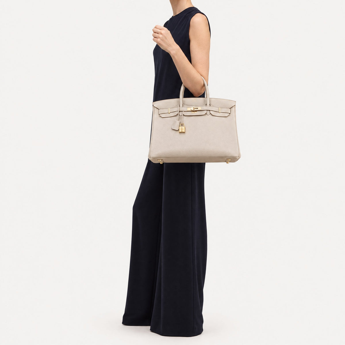 Classic 35 togo leather tote in white carried on the arm, model shot