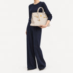 Classic 40 togo leather tote in white carried under the arm, model shot