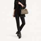 Weekday Tote Mini 23 cm open-top tote in khaki carried in the crook of the arm with a black blazer and slim trousers, model shot