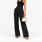 Weekday Tote Mini 23 cm open-top tote in white carried by the top handles with a black tank and black wide-leg trousers, model shot