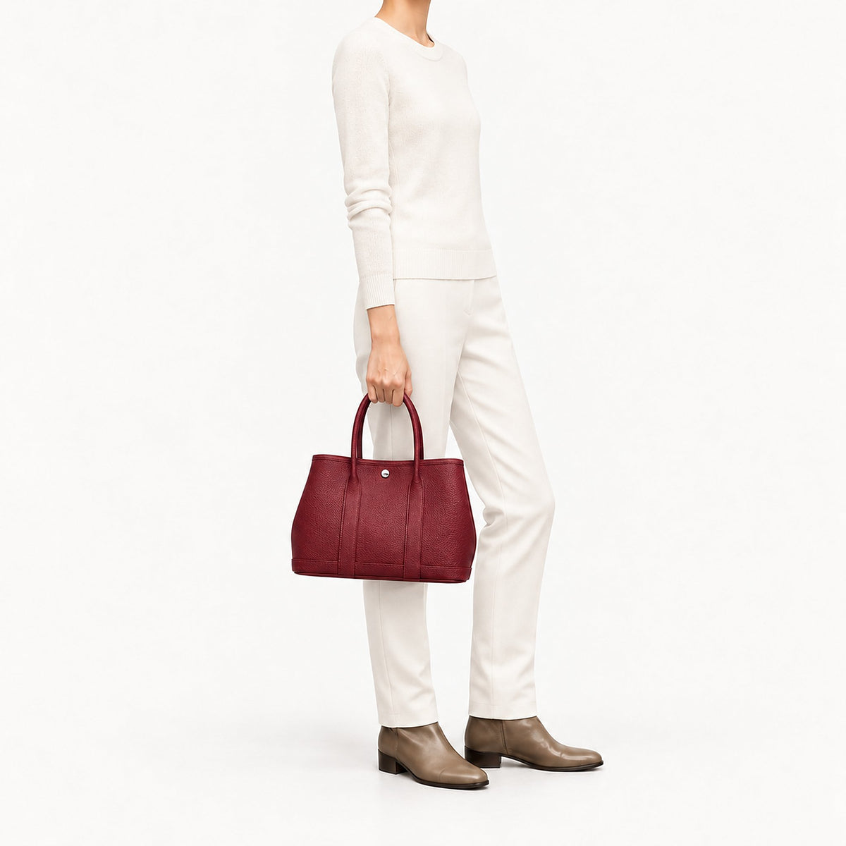 Weekday Tote Medium 30 cm open-top tote in burgundy carried by the top handles with an all-cream knit outfit, model shot