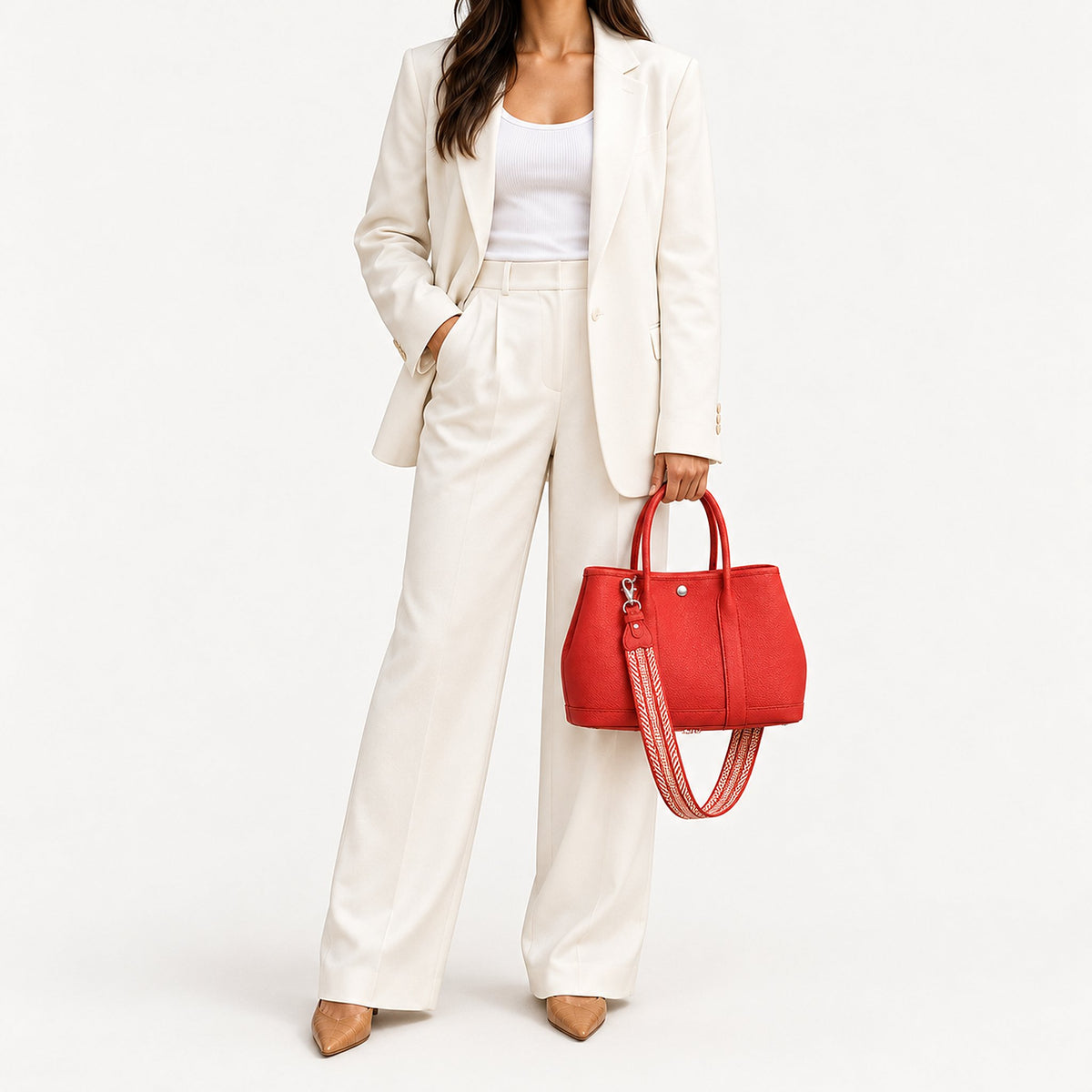 Weekday Tote Medium 30 cm open-top tote in red carried by hand with the included woven strap, styled with a cream trouser suit, model shot